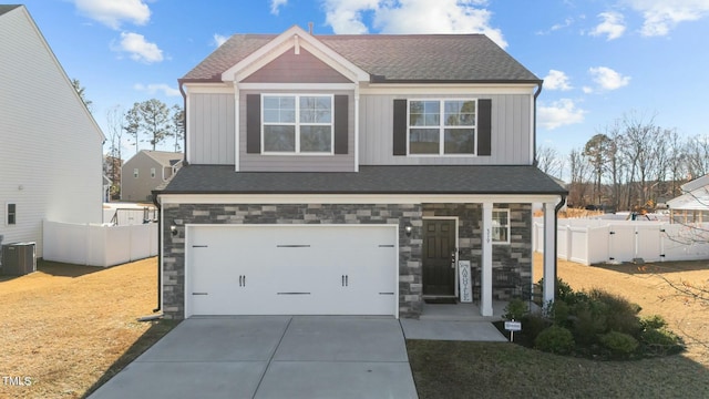 craftsman-style home featuring central AC, a garage, and a front lawn