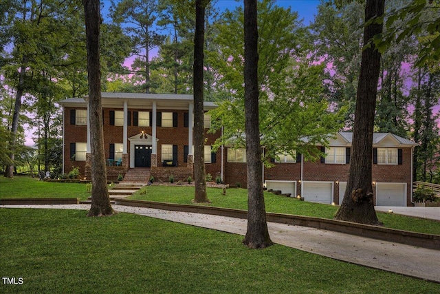 view of front facade with a lawn and a garage