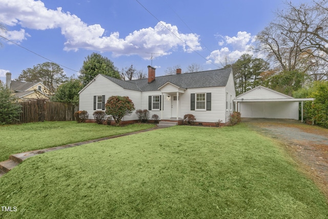 view of front of home with a front yard, an outdoor structure, and a garage