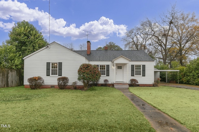 ranch-style home featuring a front lawn and a carport