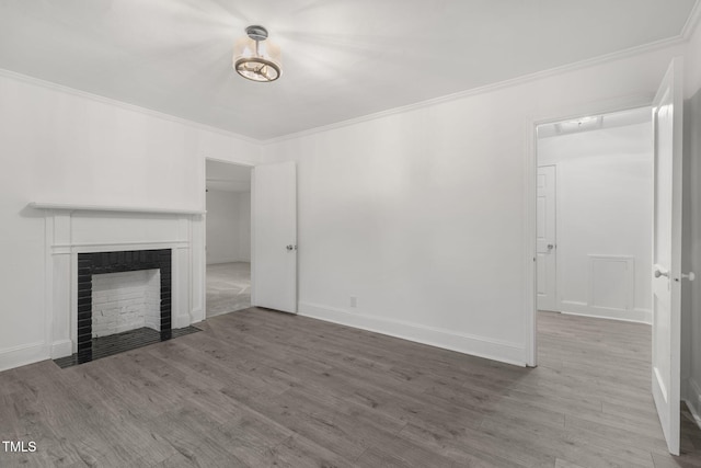 unfurnished living room featuring hardwood / wood-style flooring and ornamental molding