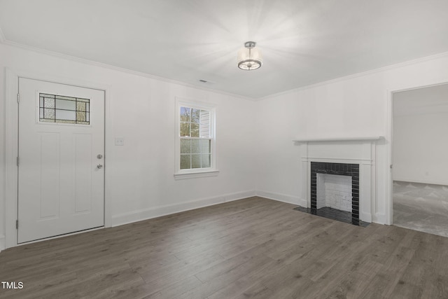 unfurnished living room featuring dark hardwood / wood-style flooring and ornamental molding