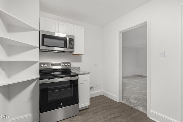 kitchen with white cabinets, dark hardwood / wood-style floors, and stainless steel appliances