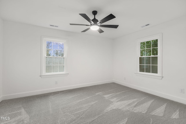 carpeted empty room featuring ceiling fan