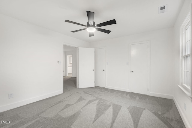 unfurnished bedroom with ceiling fan and light carpet