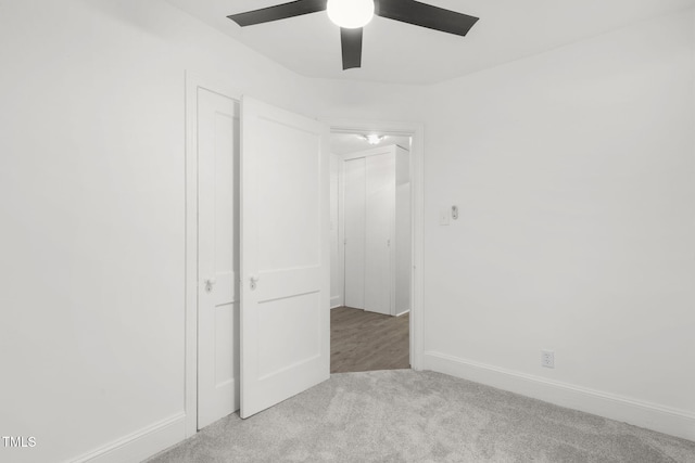 unfurnished bedroom with ceiling fan and light carpet