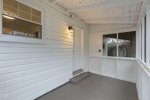 unfurnished sunroom featuring vaulted ceiling with beams and wooden ceiling