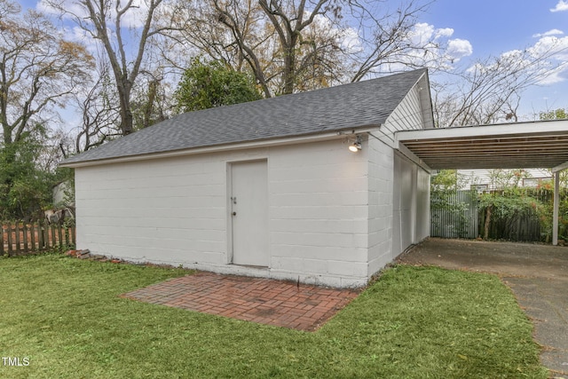 view of outbuilding with a yard and a carport