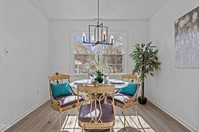 dining area with a notable chandelier and wood-type flooring