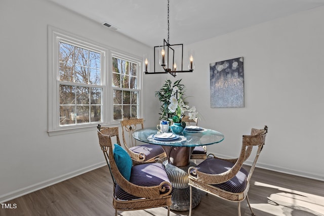 dining space with a chandelier and hardwood / wood-style flooring