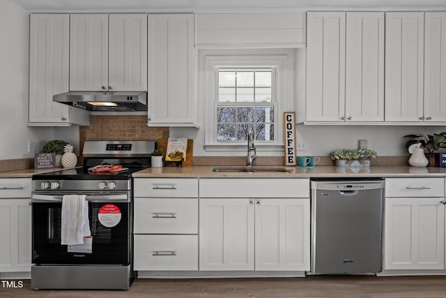 kitchen with stainless steel appliances, white cabinetry, and sink