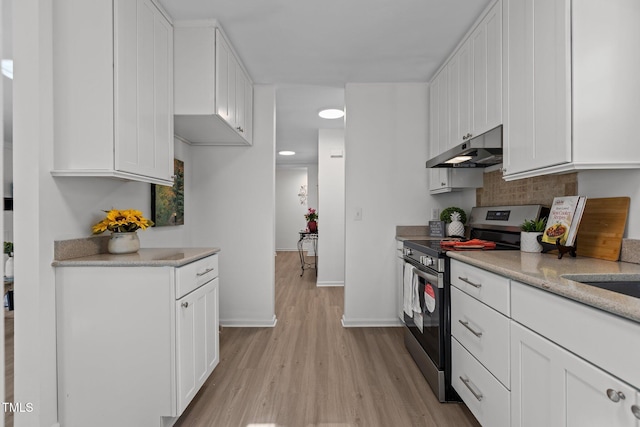 kitchen featuring light hardwood / wood-style floors, stainless steel electric range, light stone counters, decorative backsplash, and white cabinets