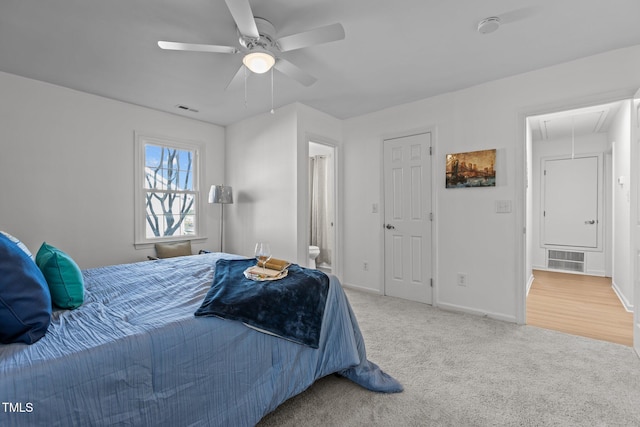 carpeted bedroom featuring ensuite bathroom and ceiling fan