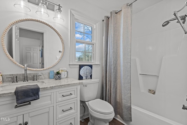 full bathroom featuring shower / bathtub combination with curtain, vanity, and toilet