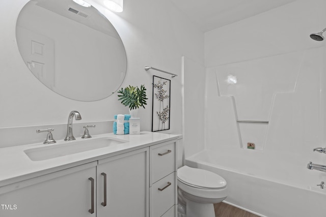 full bathroom featuring wood-type flooring, shower / tub combination, vanity, and toilet