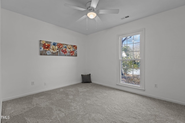 carpeted spare room featuring ceiling fan