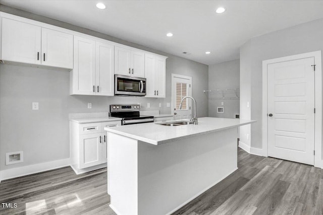 kitchen featuring white cabinetry, a kitchen island with sink, sink, and stainless steel appliances