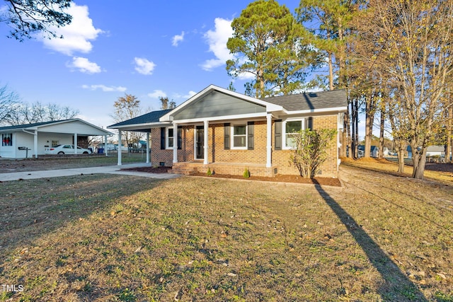 view of front of property with a porch, a carport, and a front lawn