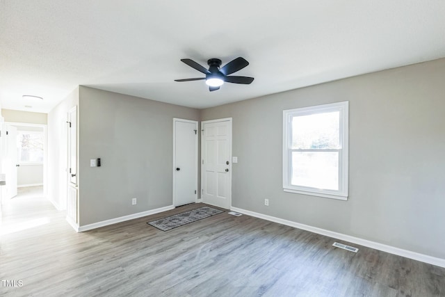 unfurnished room featuring ceiling fan and hardwood / wood-style flooring