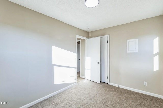 unfurnished bedroom featuring carpet and a textured ceiling