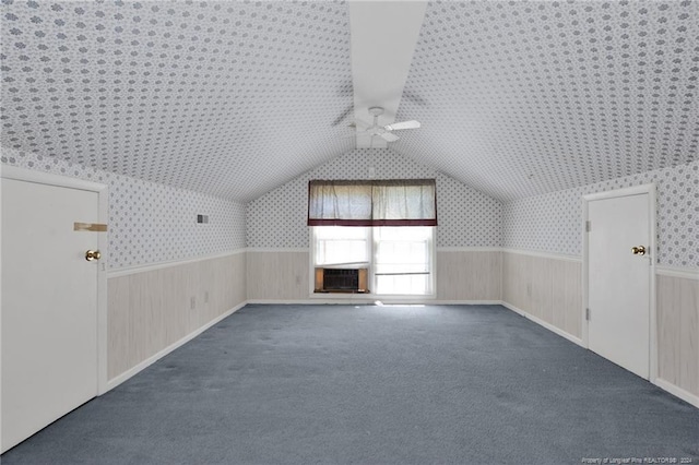 additional living space with cooling unit, ceiling fan, carpet, and lofted ceiling