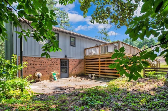 rear view of house featuring a deck