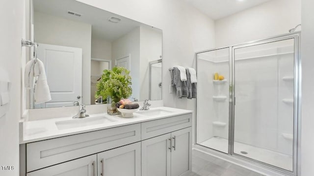 bathroom featuring vanity and a shower with shower door