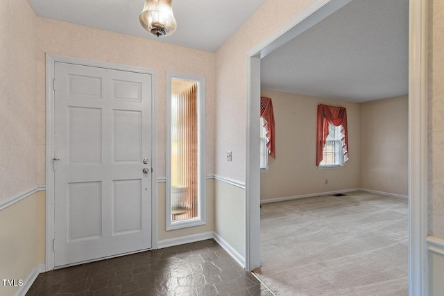 view of carpeted entrance foyer