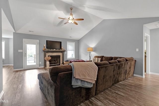 living room with ceiling fan, plenty of natural light, vaulted ceiling, and hardwood / wood-style flooring