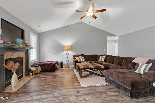 living room with hardwood / wood-style floors, vaulted ceiling, and ceiling fan