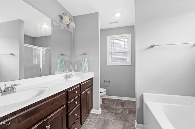 full bathroom featuring shower with separate bathtub, vanity, and toilet