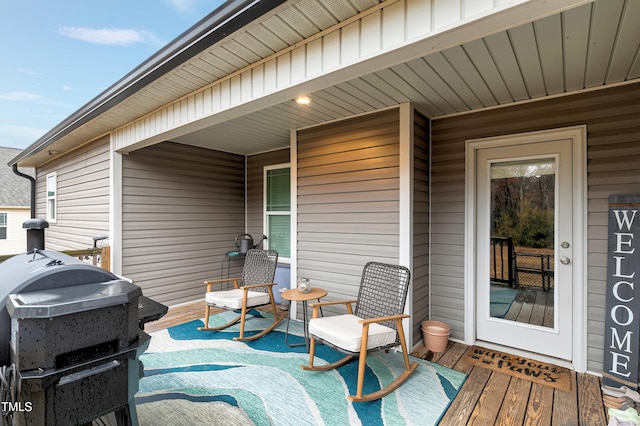 wooden deck featuring a grill