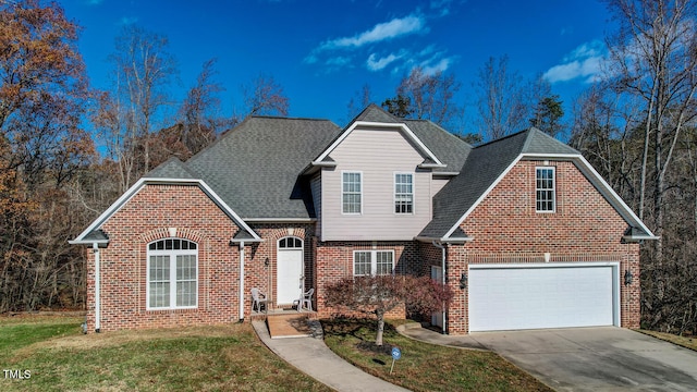 front facade with a garage and a front lawn