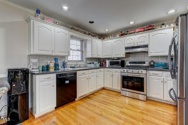 kitchen featuring appliances with stainless steel finishes, light hardwood / wood-style floors, and white cabinetry