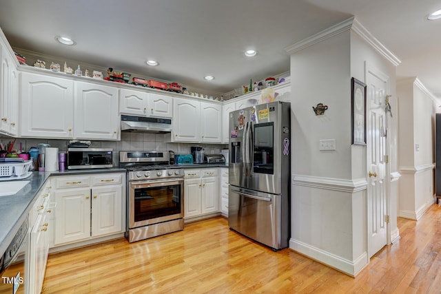 kitchen with backsplash, ornamental molding, stainless steel appliances, light hardwood / wood-style flooring, and white cabinets