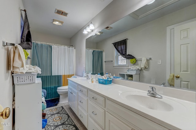 bathroom featuring tile patterned flooring, vanity, and toilet