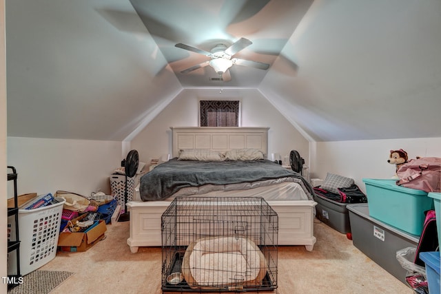 carpeted bedroom featuring ceiling fan and vaulted ceiling