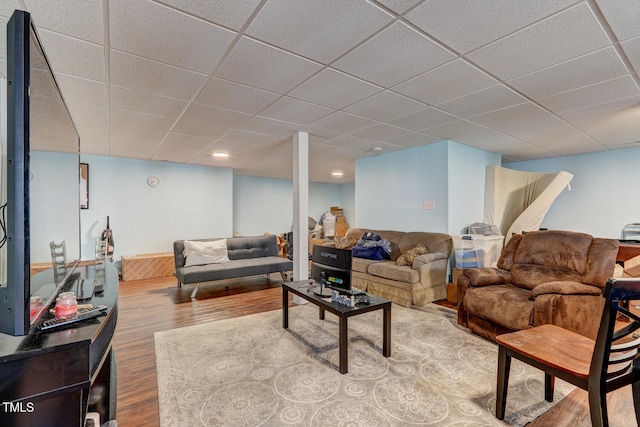 living room featuring a paneled ceiling and hardwood / wood-style flooring