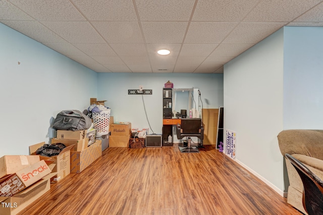 office space featuring hardwood / wood-style floors and a paneled ceiling