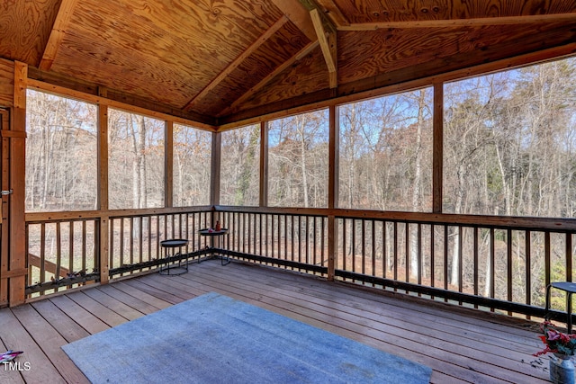 unfurnished sunroom with lofted ceiling with beams, wooden ceiling, and a wealth of natural light