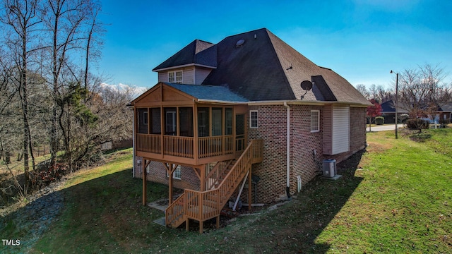 back of property featuring a yard, cooling unit, and a sunroom