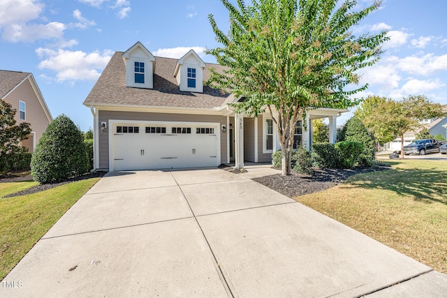 view of front of property featuring a front yard and a garage