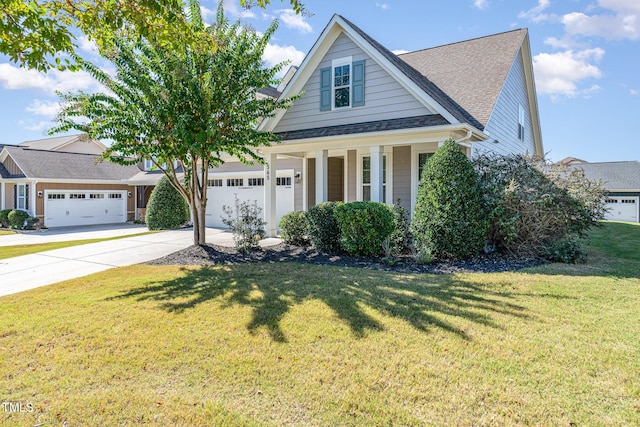 view of front facade with a front yard, a porch, and a garage