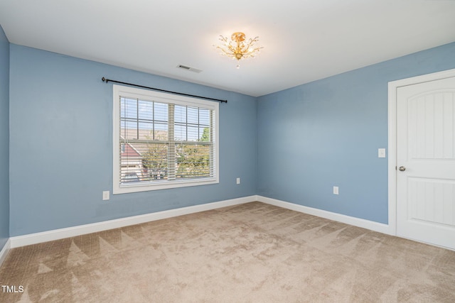 unfurnished room featuring light carpet