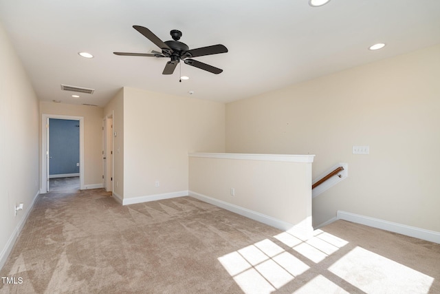 empty room with light colored carpet and ceiling fan