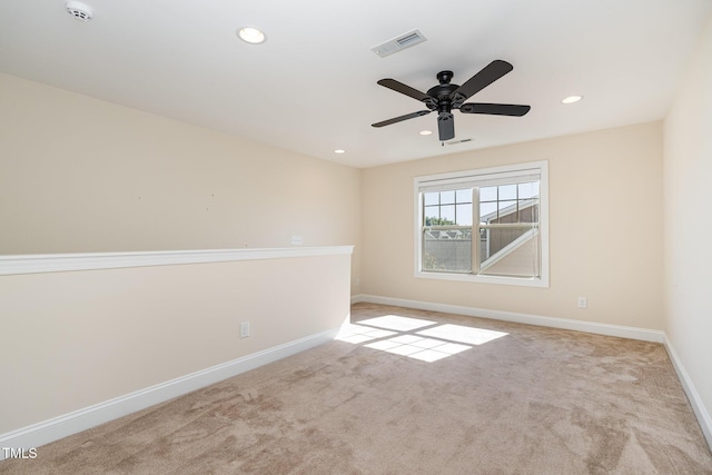 carpeted spare room featuring ceiling fan