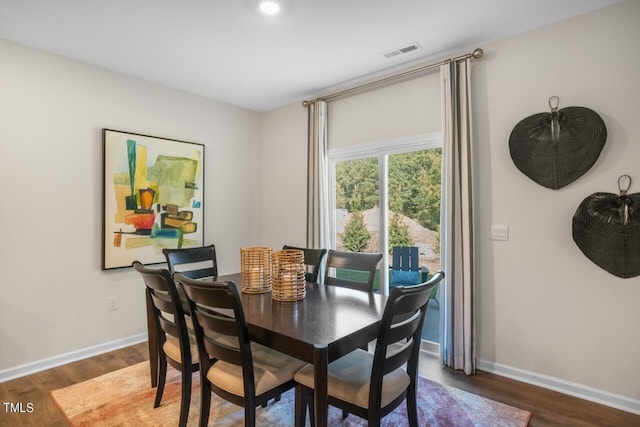 dining space featuring dark hardwood / wood-style flooring