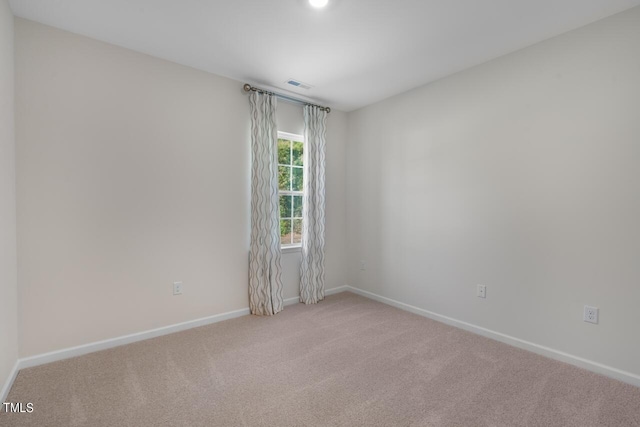 spare room with light colored carpet