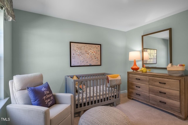 bedroom featuring light colored carpet and a crib