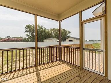 unfurnished sunroom with a water view